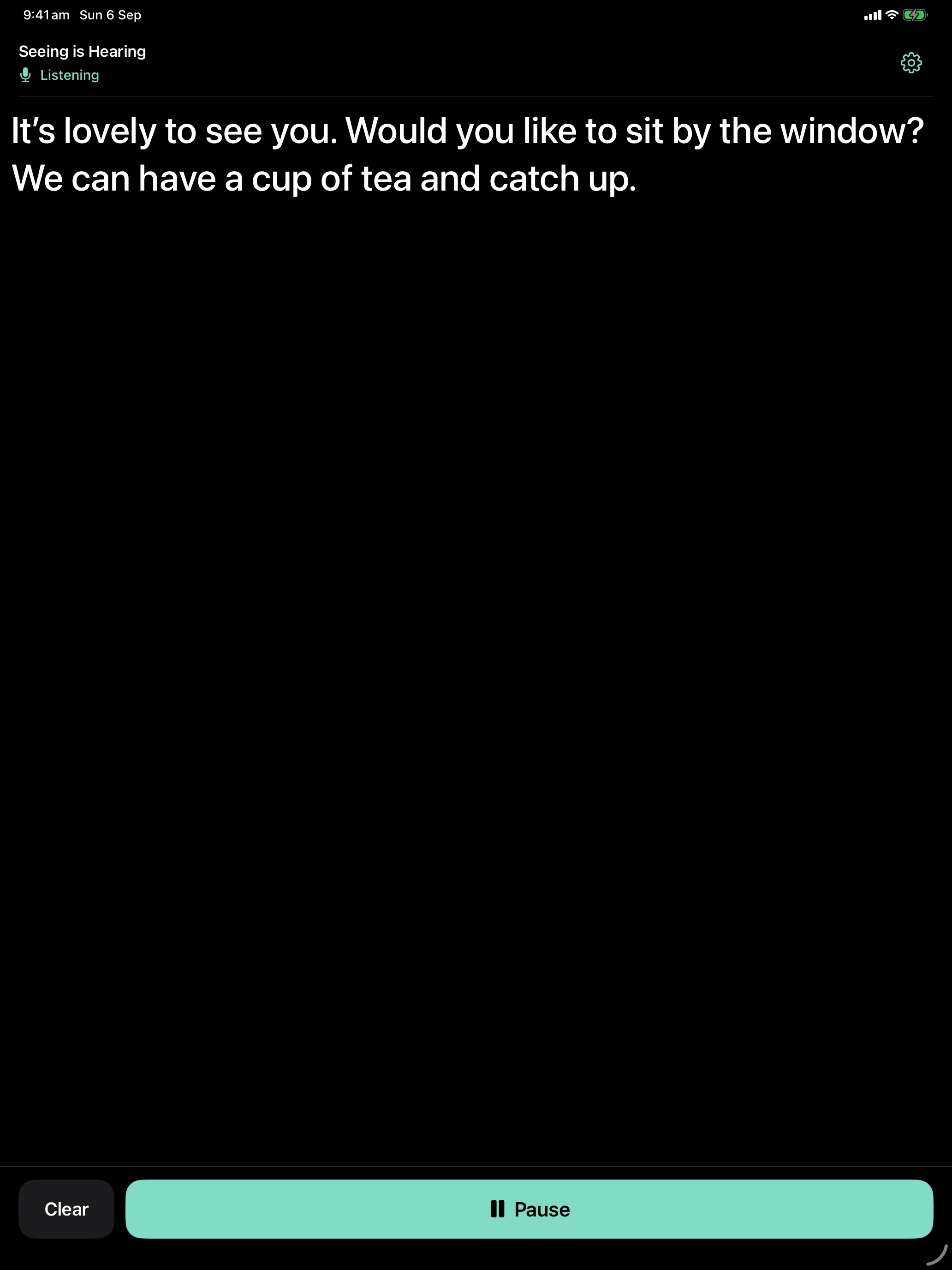 Seeing is Hearing on iPad, with large live captions on a wider dark reading screen.
